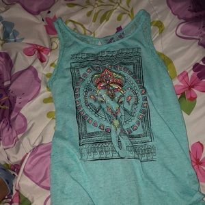 A blue tank top with a elaphat on it